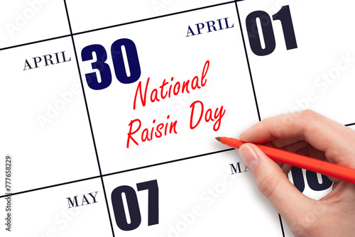 April 30. Hand writing text National Raisin Day on calendar date. Save the date. © Alena