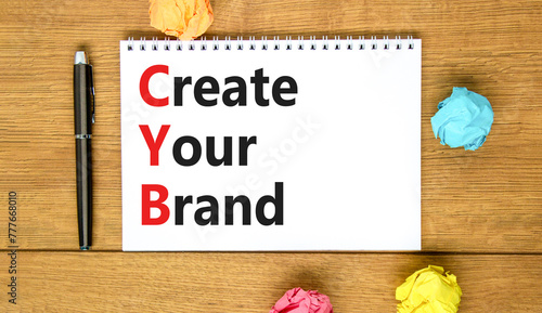 CYB Create your brand symbol. Concept words CYB Create your brand on beautiful white note. Beautiful wooden table wooden background. Business CYB Create your brand concept. Copy space.