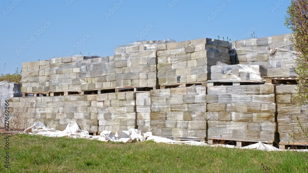 Concrete Block Bricks Wrapped in Plastic Stacked on Transport Euro Pallets