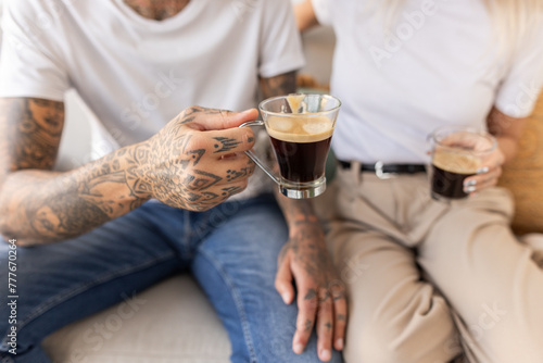 two people holding a black coffee photo