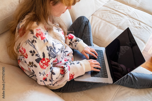 Woman working from her living room on lap top photo