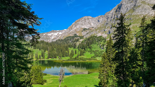 Panoramic view of alpine lake Sackwiesensee surrounded by majestic Hochschwab mountains, Styria, Austria. Wanderlust in wilderness of untamed Austrian Alps, Europe. Idyllic hiking atmosphere in summer photo