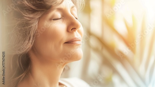 Close-up face of focused middle-aged woman doing breathing yogic practices at home. Woman with closed eyes meditating. Close-up. Banner.