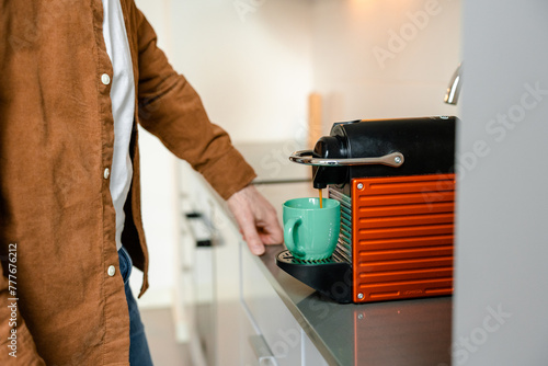 A man makes coffee at home photo
