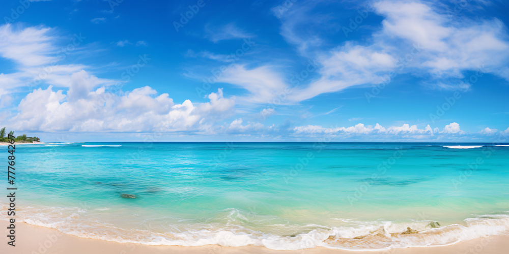 Empty sand beach with blue ocean with blue sky with clouds on sunny day