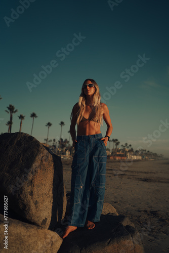 Stylish woman on the beach with trendy clothes  photo