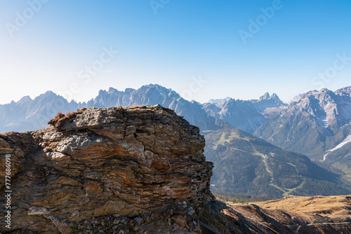 Remains of military bunker of First World War on mount Hornischegg with scenic view of mountain peaks of untamed Sexten Dolomites, South Tyrol, border Austria Italy, Europe. Wanderlust concept in Alps