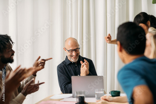 Coworkers applauding in office