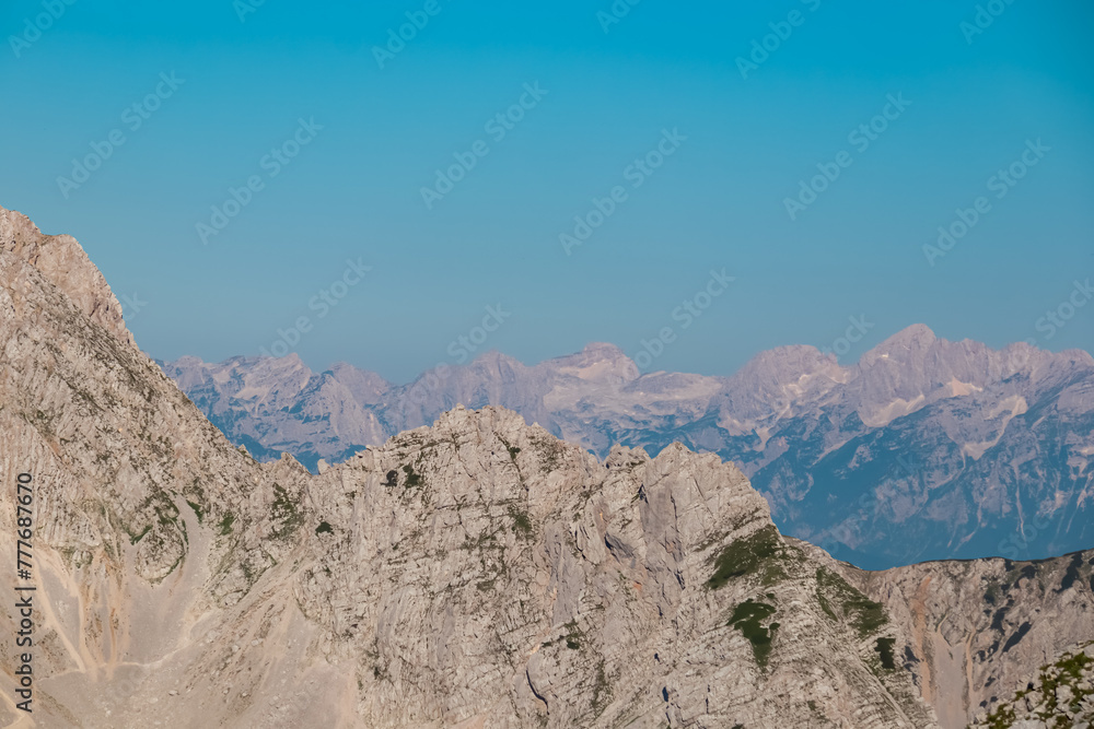 Scenic view of majestic mountain peak Hochstuhl (Stol) in untamed Karawanks, border Slovenia Austria. Looking from Vertatscha peak. Hiking wanderlust in wilderness of Slovenian Alps in summer