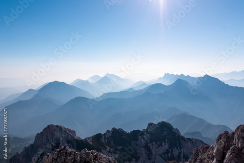 Scenic view of Koschuta mountain range seen from summit Wertatscha in untamed Karawanks, border Slovenia Austria, Europe. Hiking trail on Loibl Pass. Magical alpine terrain Slovenian Austrian Alps photo