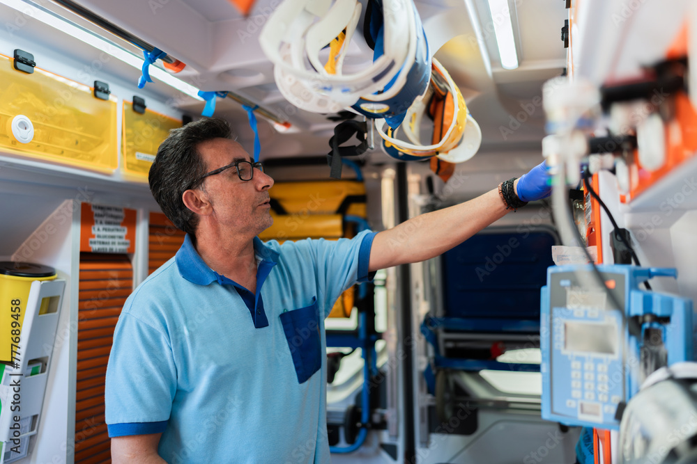 paramedic in blue uniform working in an ambulance paramedic in blue uniform working in an ambulance