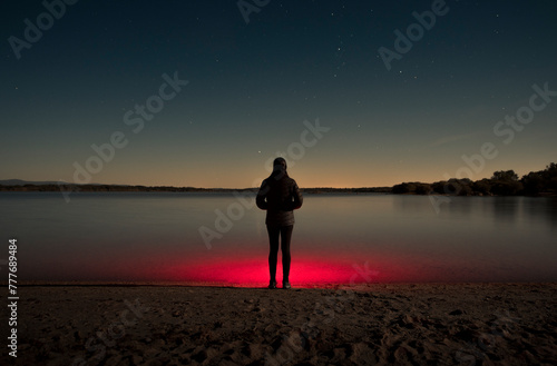 Surreal portrait of woman standing under the stars photo