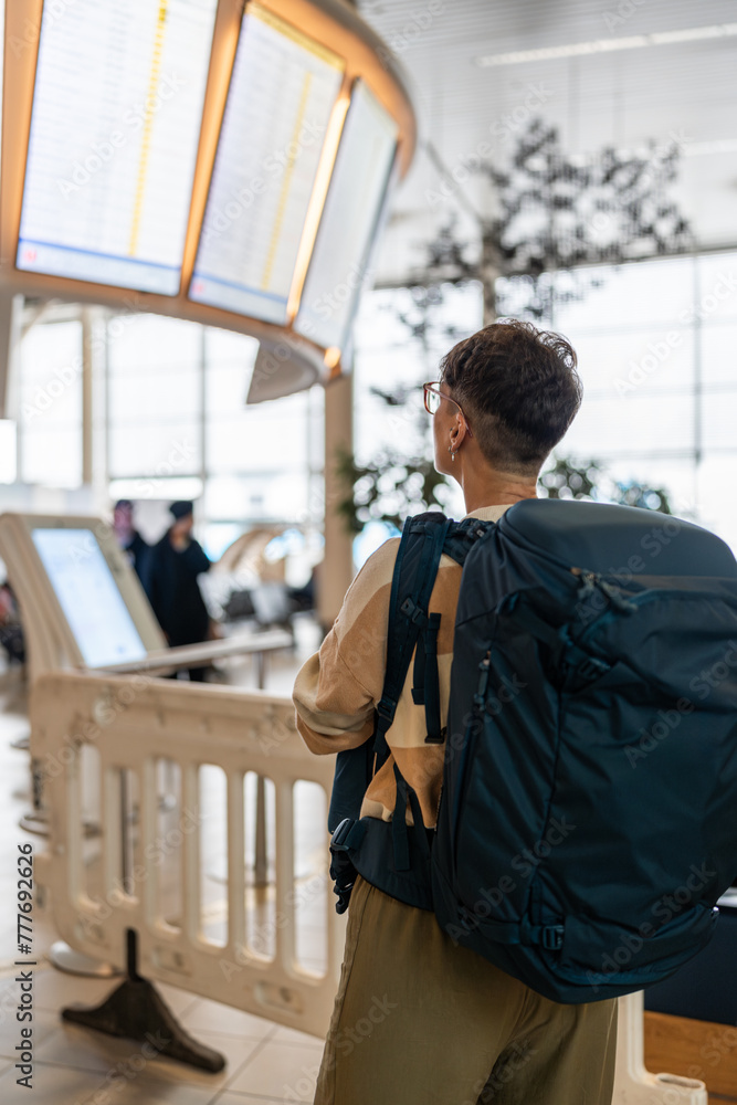 Traveler checking the information board. Traveler checking the information board.
