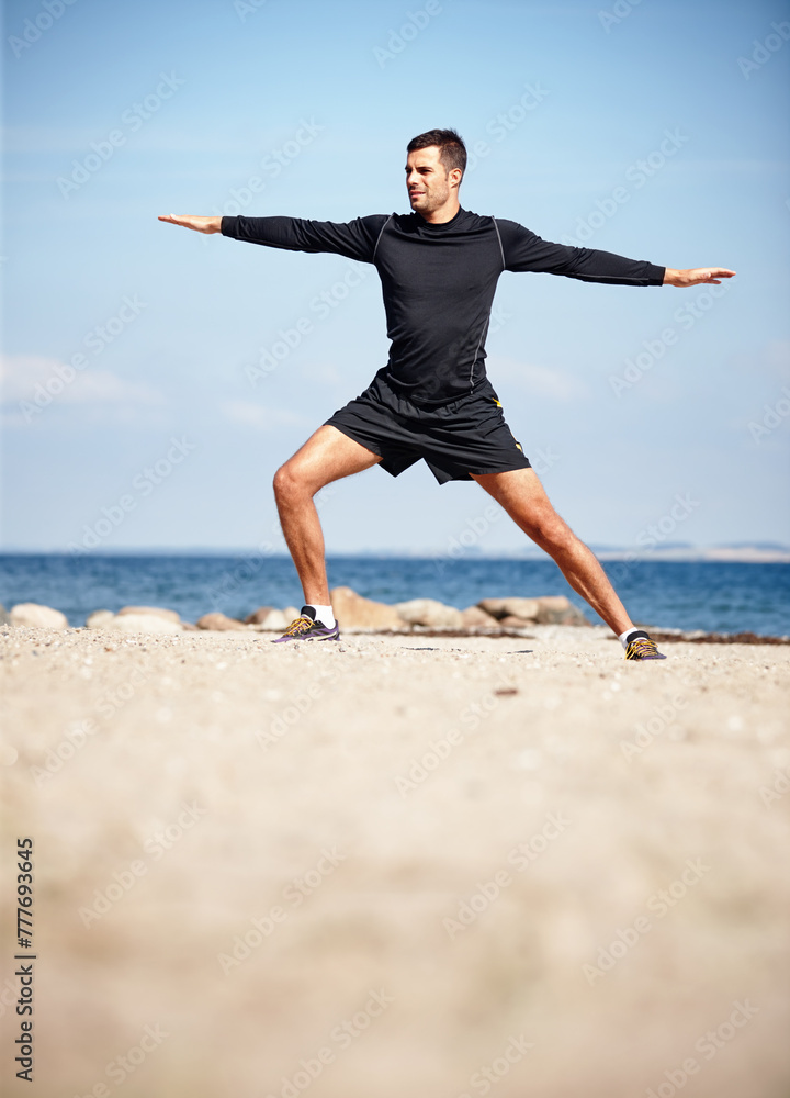 Athlete, stretching and beach on sand with shoes for health, fitness and exercise by ocean for peace and calm. Man, yoga and sea in morning for wellness, motivation and workout or training by nature Athlete, stretching and beach on sand with shoes for health, fitness and exercise by ocean for peace and calm. Man, yoga and sea in morning for wellness, motivation and workout or training by nature