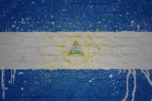 painted big national flag of nicaragua on a massive old brick wall