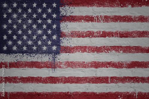 painted big national flag of united states of america on a massive old brick wall