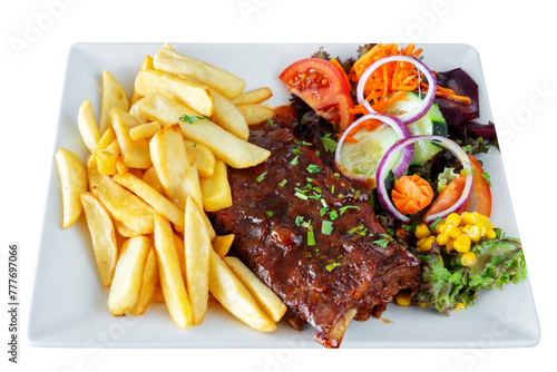 A barbecue pork dish with fresh grilled ribs, home fries and a salad with assorted vegetables. On a white insulated background.