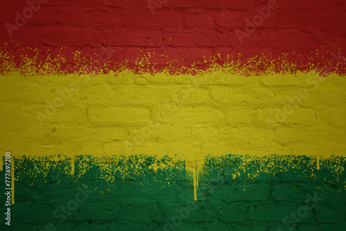 painted big national flag of bolivia on a massive old brick wall