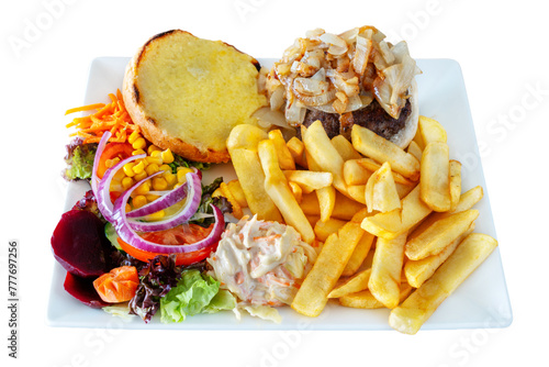 A set meal of hamburger fries salad and sauces. On a white isolated background.