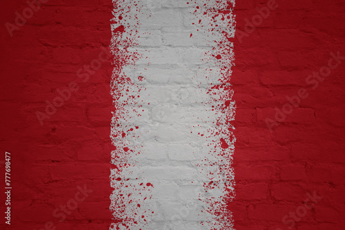 painted big national flag of peru on a massive old brick wall