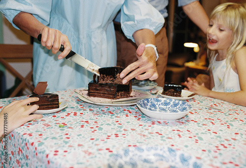 Senior woman cutting the cake photo