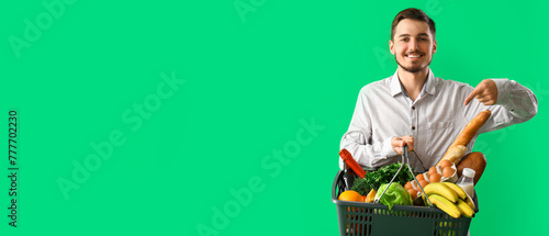 Young man pointing at shopp...