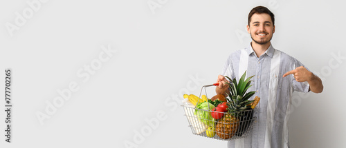 Young man pointing at shopp...