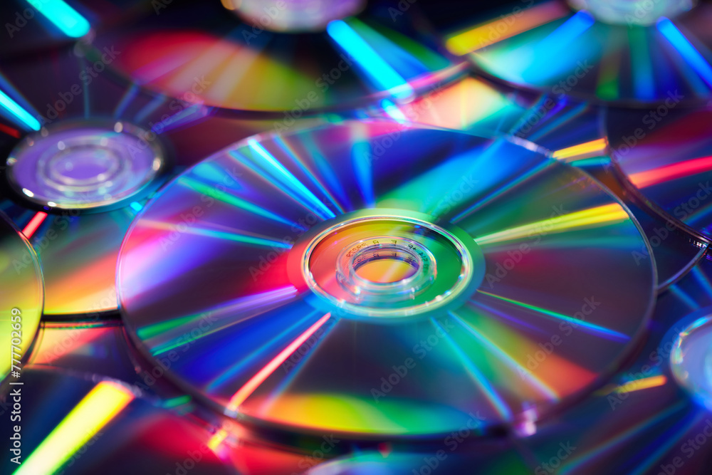 Multiple compact CD discs scattered in studio with holographic effect Multiple compact CD discs scattered in studio with holographic effect