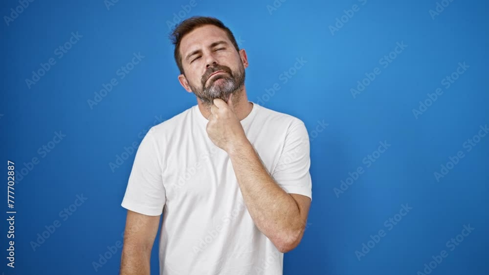 A middle-aged man with grey hair in a white shirt showing expressions of thinking and having an idea against a blue background. A middle-aged man with grey hair in a white shirt showing expressions of thinking and having an idea against a blue background.