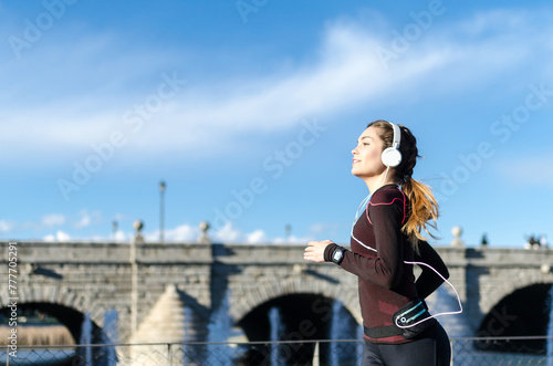 woman stretching resting after running and jogging in a park with sportswear