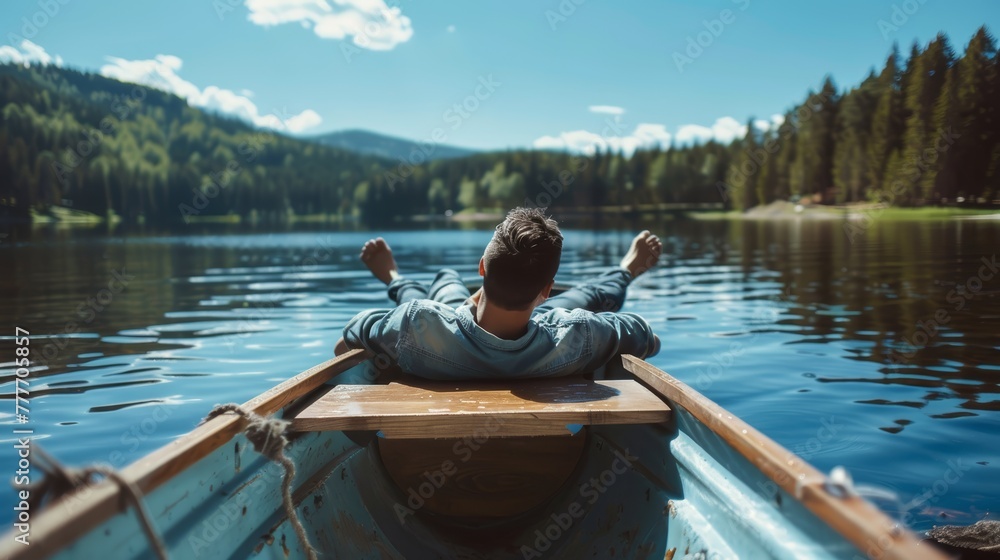 Person stretching arms in a canoe, serene lake and forest view. Freedom and nature exploration concept.