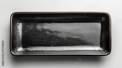 A rectangular black ceramic plate viewed from above, isolated on white with clipping path provided.