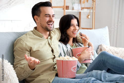 Happy couple with popcorn w...