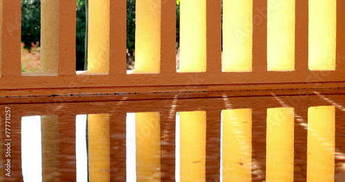 Architecture orange patterns pillars reflected on water surface