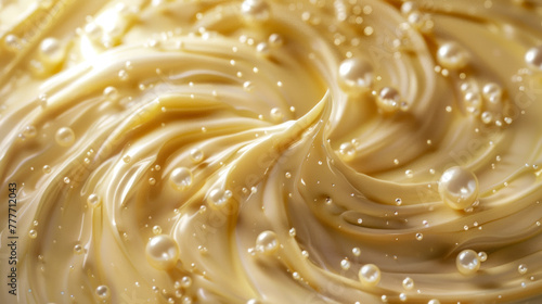 Close-up texture of swirling golden caramel with bubbles on a creamy surface