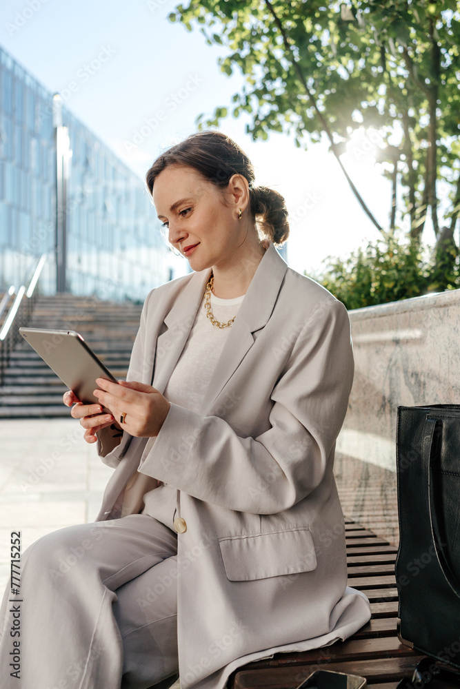 Businesswoman engrossed in digital work using tablet Businesswoman engrossed in digital work using tablet