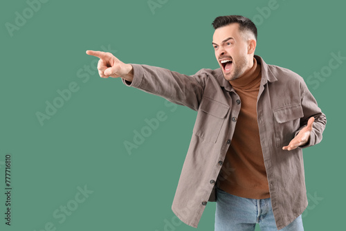 Angry young man pointing at...