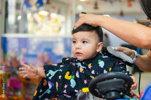 Baby haircut at a baby hairdresser photo