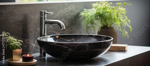 black marble round vessel sink and chrome faucet. Minimalist interior of modern bathroom