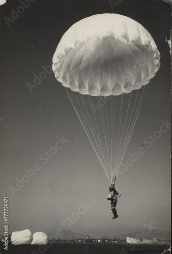 1969.  Parachutist prepares for landing.
 photo