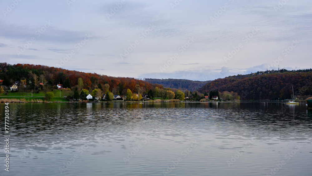 A lake in autumn that surrounds a village A lake in autumn that surrounds a village