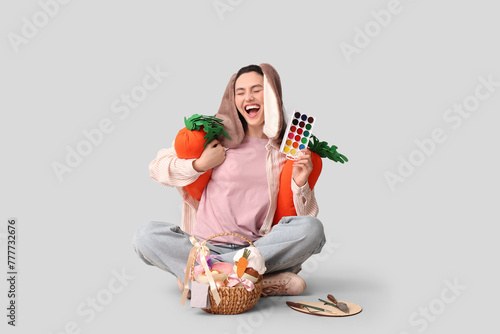 Joyful woman in bunny ears ...