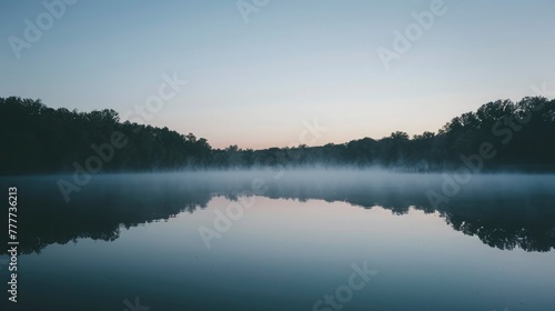 A tranquil lake at dawn, the water perfectly mirroring the sky and surrounding trees, a thin mist hovering above the surface, conveying a sense of peace and solitude