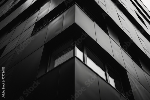 Close-up view of a modern skyscraper with reflective facade creating a visual interplay of light and dark, suited for urban design themes.