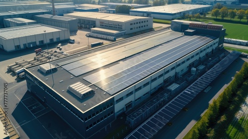 Aerial view of modern industrial facility with solar panels on roof photo