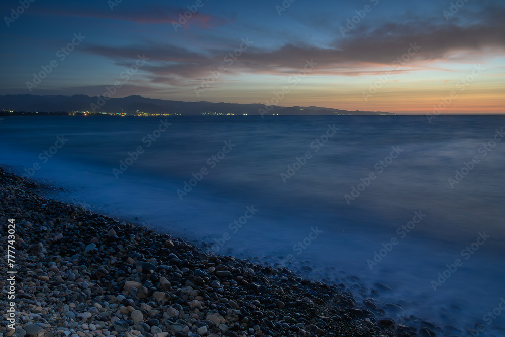 Sea shore area and horizon during sunset, blue hour.