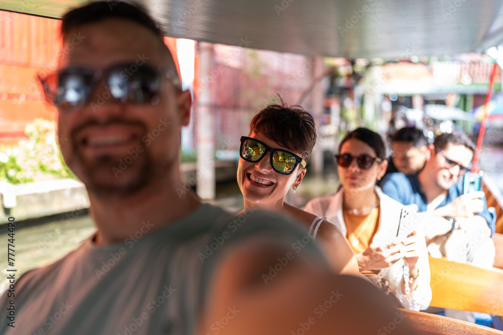 Tourist couple on a boat in Bangkok. Tourist couple on a boat in Bangkok.