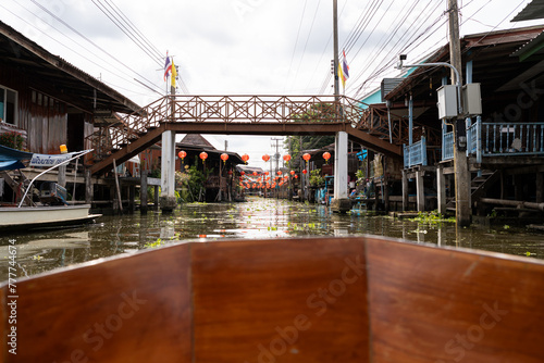 Boat sailing at Thai floating market.