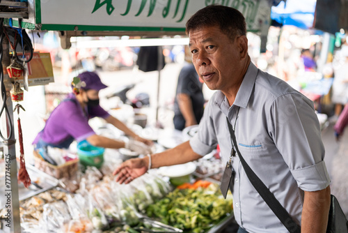 Thai man in a street market. photo