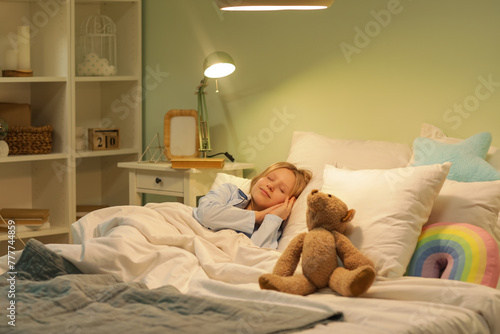 Adorable girl with teddy be...